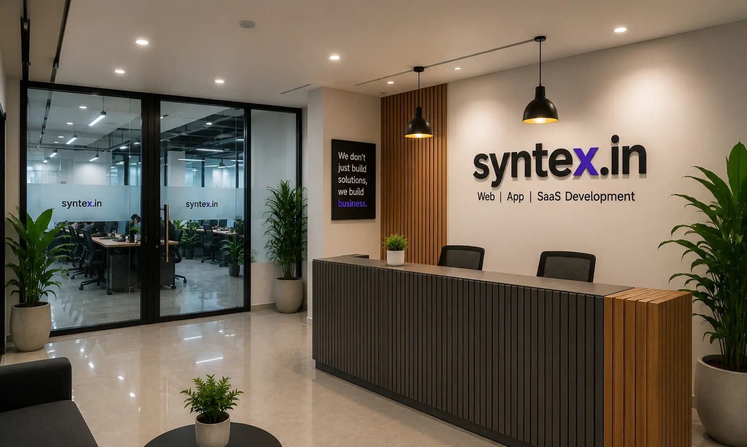 The Fiverr reception in New Delhi — the studio wall behind the desk, with the open workspace through the glass