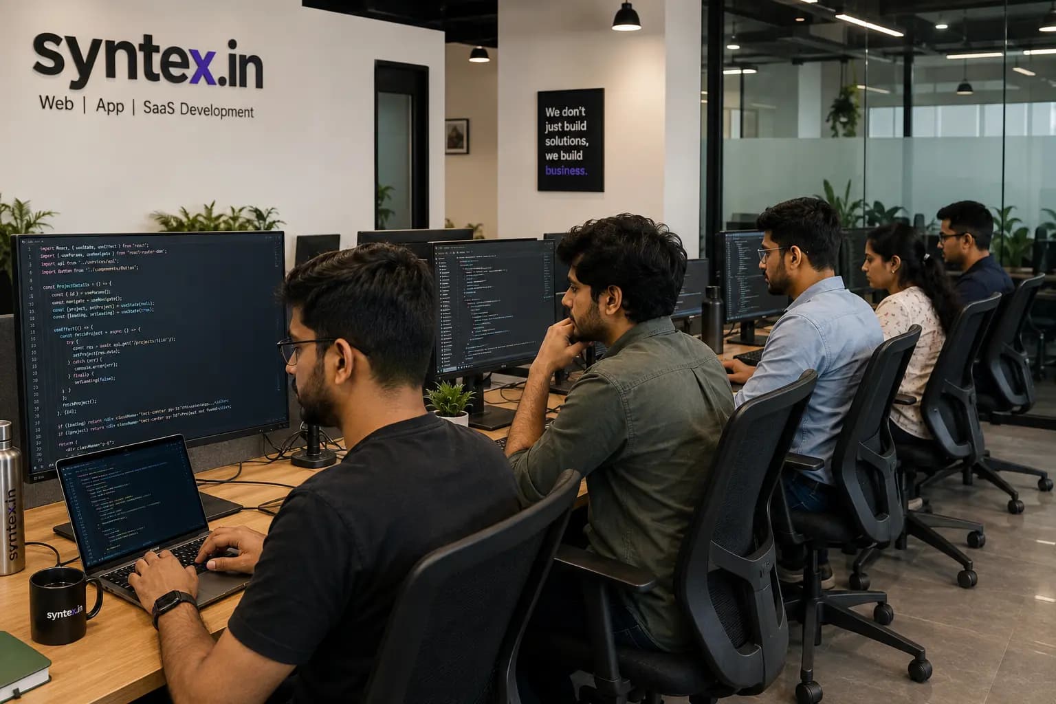The Fiverr team at work in the New Delhi studio, React code on the monitors